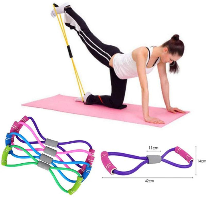 A person is working out on a pink yoga mat, utilizing a Slimming Yoga Resistance Band for leg stretches. Nearby, there are vibrant looped bands with adjustable resistance levels, ideal for a full-body workout. The setup measures 42cm in length and 14cm in height.