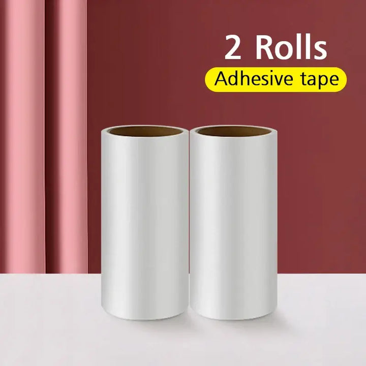 Two rolls of adhesive tape on a table, ideal for pet hair removal, against a pink and red background.