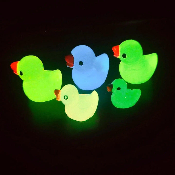 Five Nightglow Duck Decals Cartoon stickers are designed to glow in the dark in vibrant colors such as blue, yellow, and green. These 3D Kid's Room Decorations can be randomly arranged against a black background to create a playful scene.