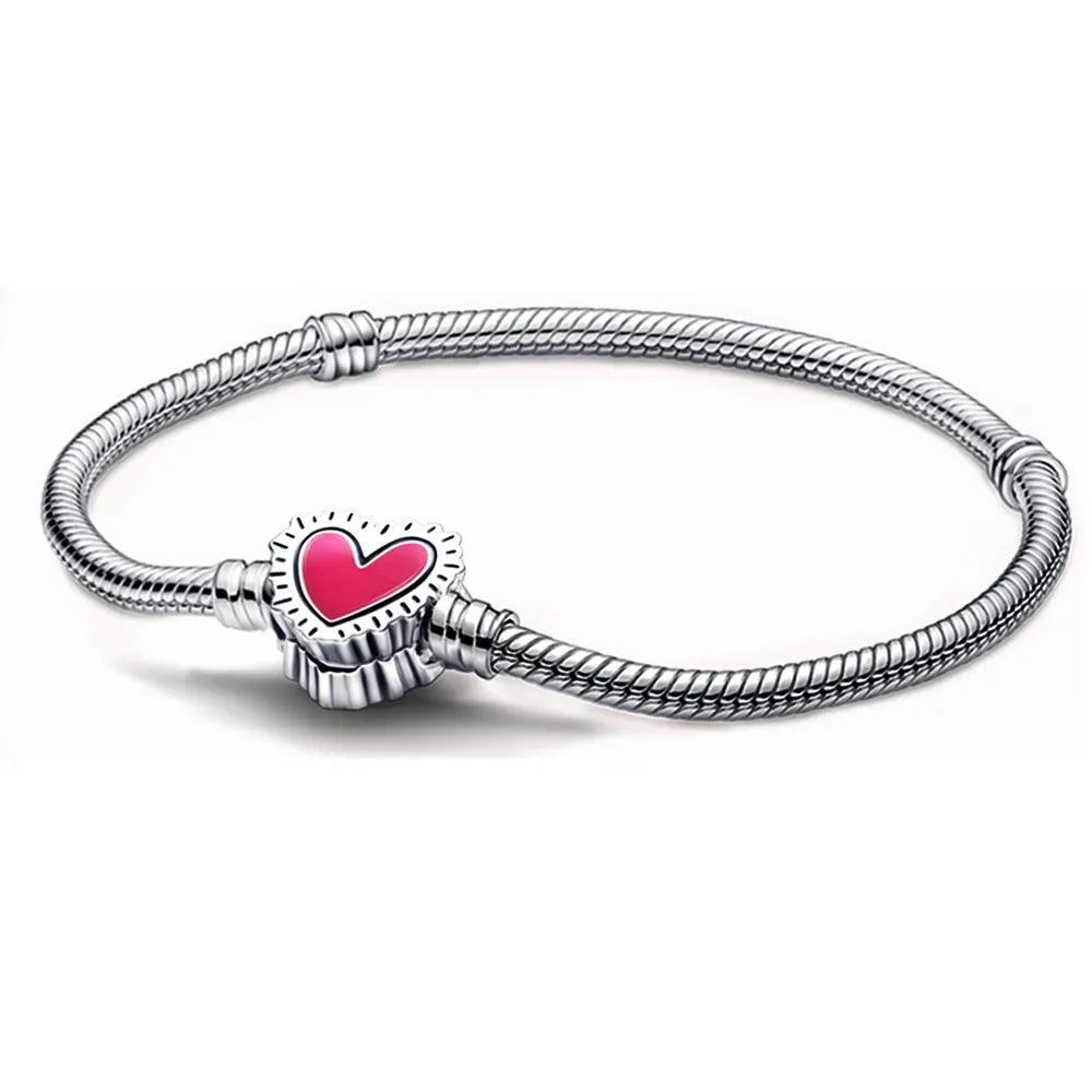 The Disney 925 Sterling Silver Bracelet Mickey Mouse Charm Bracelet showcases a rope-like texture and is adorned with a clasp featuring a red heart beautifully encased in a shimmering zircon-embellished frame.