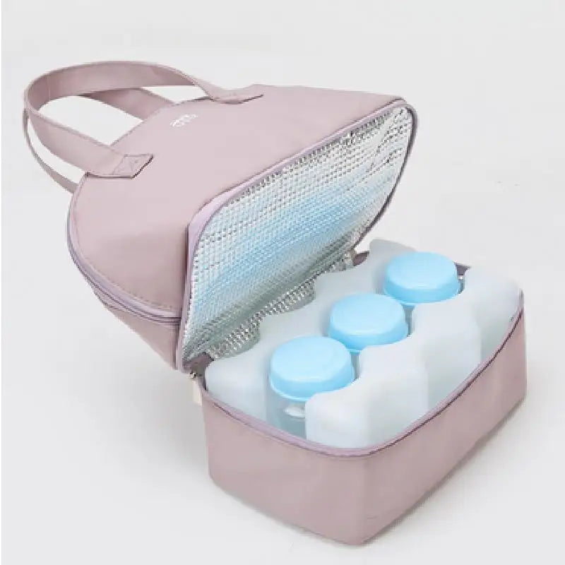 The Insulation Bag Breastfeeding, Breast Pump Cooler Bag, Milk Storage Bag, designed with thermal insulation technology and an open top in pink, holds multiple translucent white bottles with blue caps. It comes equipped with two handles and a silver interior lining, making it perfect for keeping items cool and secure.