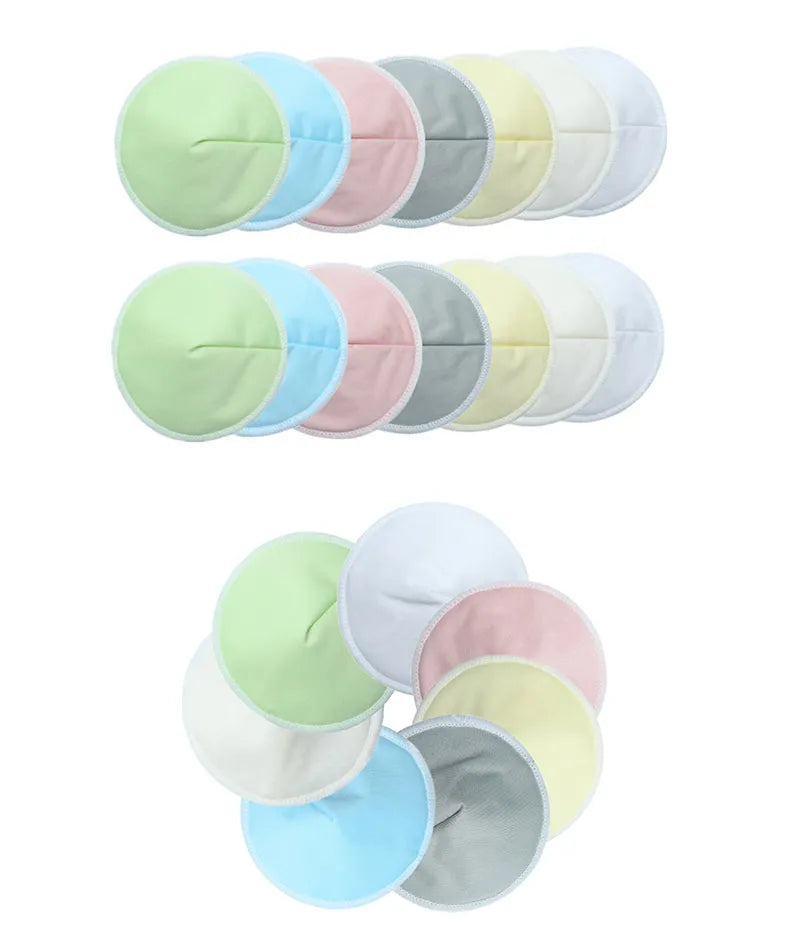 A set of vibrant, round Organic Washable Breast Pads Reusable Nipple Covers Eco-friendly Maternity Essential is beautifully displayed in two lines and a circle. These eco-friendly nursing pads boast an array of pastel hues such as green, pink, blue, gray, and cream.