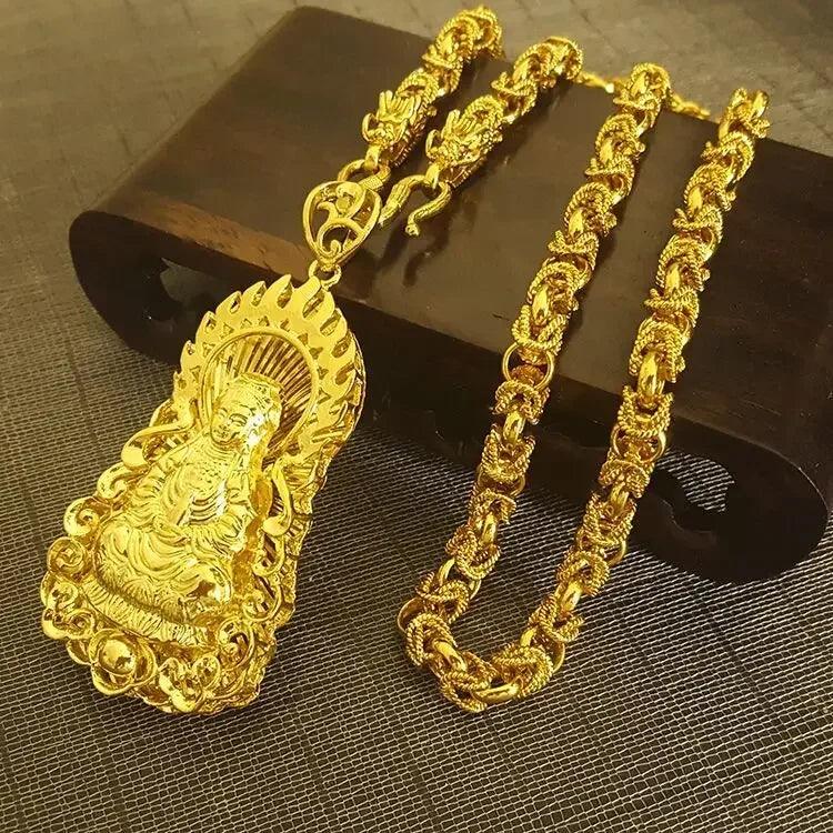 A luxurious gold necklace, adorned with an intricate pendant of a seated figure encircled by flames, elegantly lies on a dark wooden box. This handcrafted piece features an ornate link design that highlights the detailed artistry of the Men's 24K Gold Dragon Pendant Guan Gong Necklace.