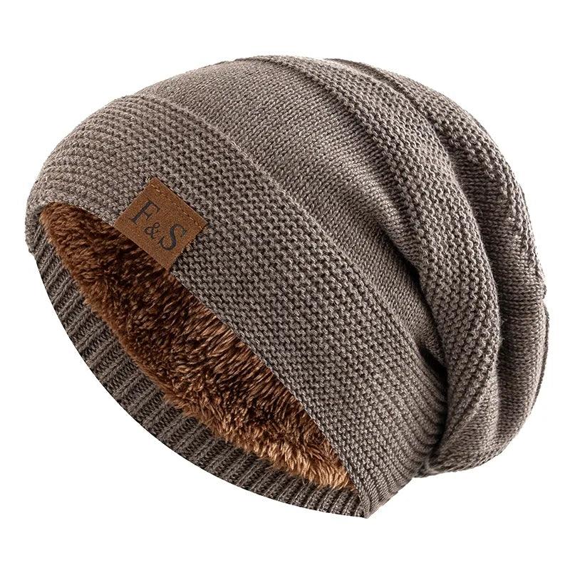 A brown Winter Hats with Fur Lining boasts a cozy knitted pattern, featuring a stylish beanie design with a small leather "F & S" patch on the side.