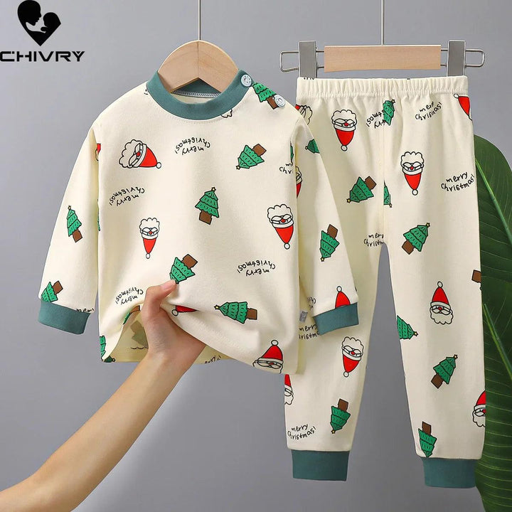 These cream-colored children's pajamas in soft cotton feature green cuffs and delightful Christmas-themed prints of Santa Claus, trees, and "Merry Christmas" text. Complete with a long-sleeve top and pants on a hanger, this Kids Pajamas Cartoon Dinosaur Toddler Clothing Set adds holiday cheer to bedtime.