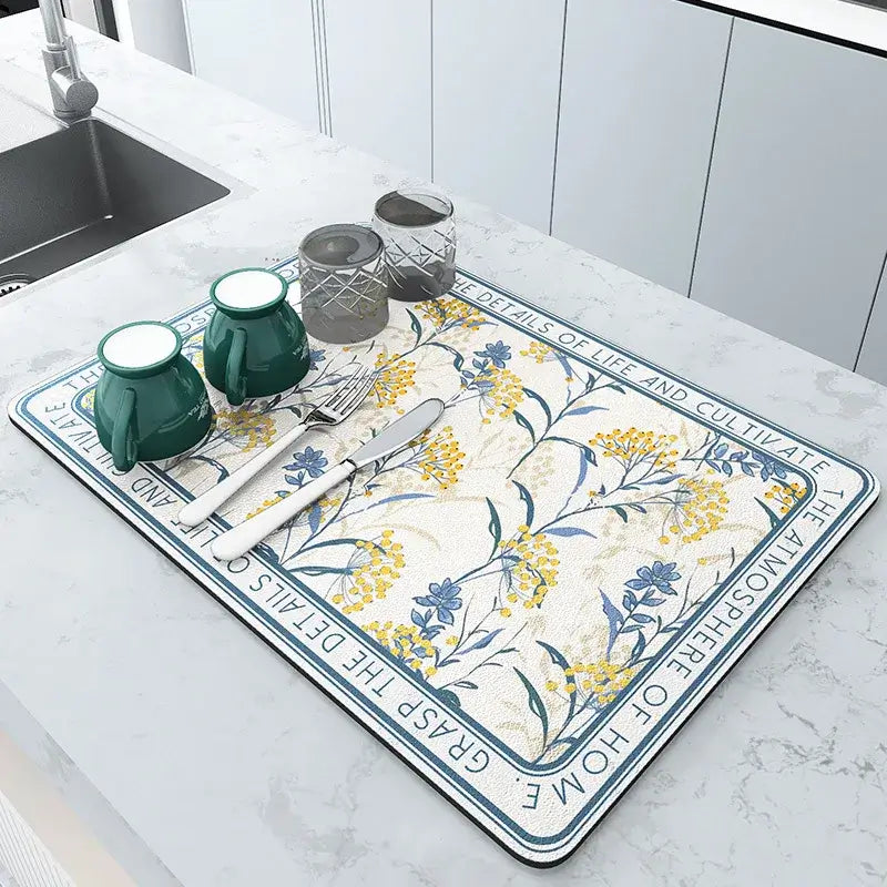 Decorative kitchen mat with floral design, diatom mud material, placed on countertop with cups and utensils, eco-friendly and quick-drying.