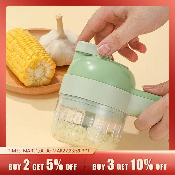 A hand operates a green Multifunctional Electric Vegetable Slicer to chop garlic, with a garlic bulb and corn on a plate in the background. A promotional banner offers discounts for purchasing multiple items.