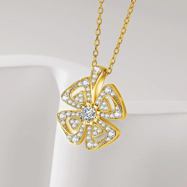 The "Necklace Moissanite, Jewelry Round Cut Diamond" features an exquisite gold chain adorned with a flower-shaped pendant. Its intricate design centers around a round-cut Moissanite diamond, surrounded by several petal-like segments encrusted with smaller stones. This piece is set against a neutral background, emanating timeless elegance.