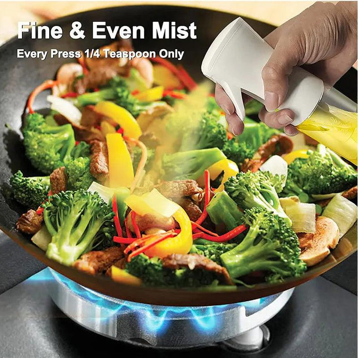 A hand spritzes oil from the "Oil Spray Bottle - Kitchen BBQ Cooking Olive Oil Dispenser - Camping Baking Empty Vinegar Soy Sauce Spray" onto a stir-fry dish with broccoli, bell peppers, onions, and meat sizzling over a gas stove. Text reads: "Fine & Even Mist - Every Press 1/4 Teaspoon Only.