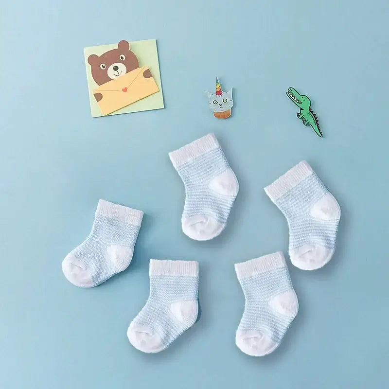 Five blue striped baby socks on a blue background with cute animal decorations, 0-6 months, soft cotton, unisex spring and summer accessory.