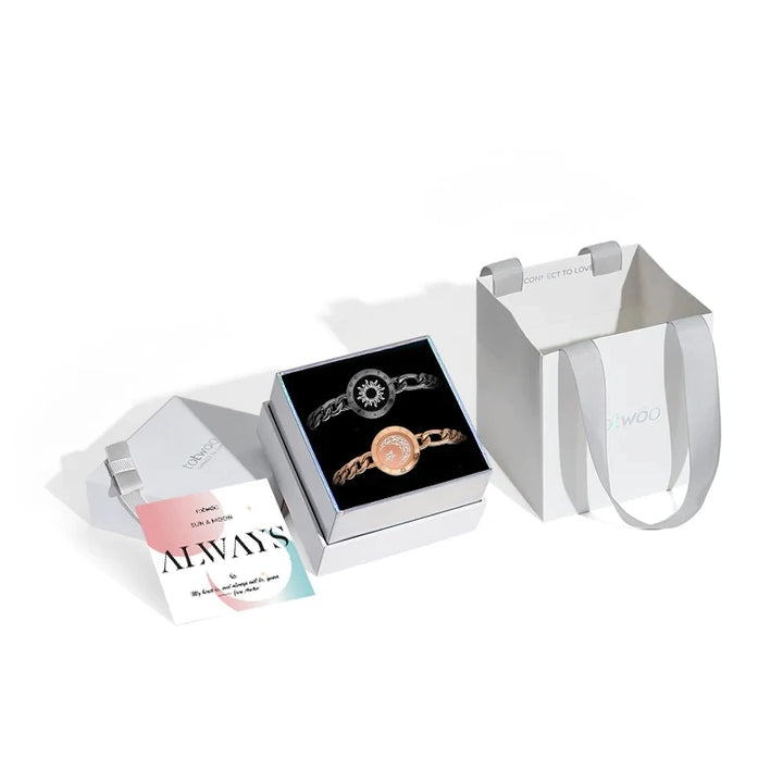 The Long Distance Bracelet Couple's Jewelry Interactive Love Gift includes two bracelets, one showcasing a sun design and the other a moon, symbolizing long distance love. It comes elegantly packaged in a stylish box with a small card and a white gift bag, making it the perfect way for couples to stay connected.