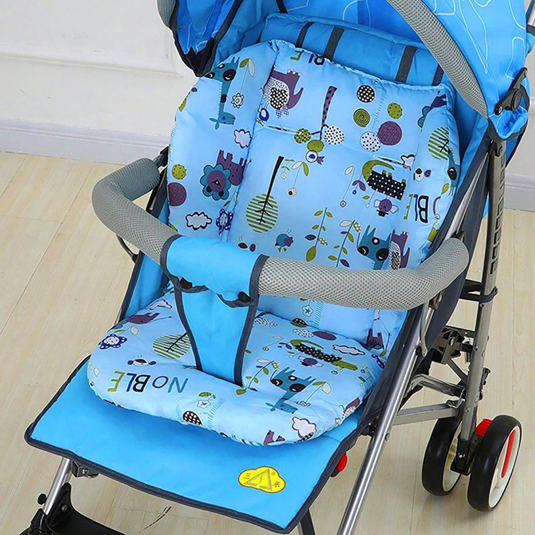 A blue baby stroller equipped with the Universal Baby Stroller Cushion Padded Trolley Seat Cushion Warm Cotton Pad, which showcases playful designs of trees, clouds, and animals such as bears and birds. This accessory enhances your child's comfort on the light wooden floor.