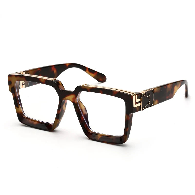 The Square Oversized Sunglasses feature a thick tortoise shell frame with gold hinge accents. These luxurious sunglasses offer modern style along with UV400 protection, boasting clear lenses for a chic appearance.