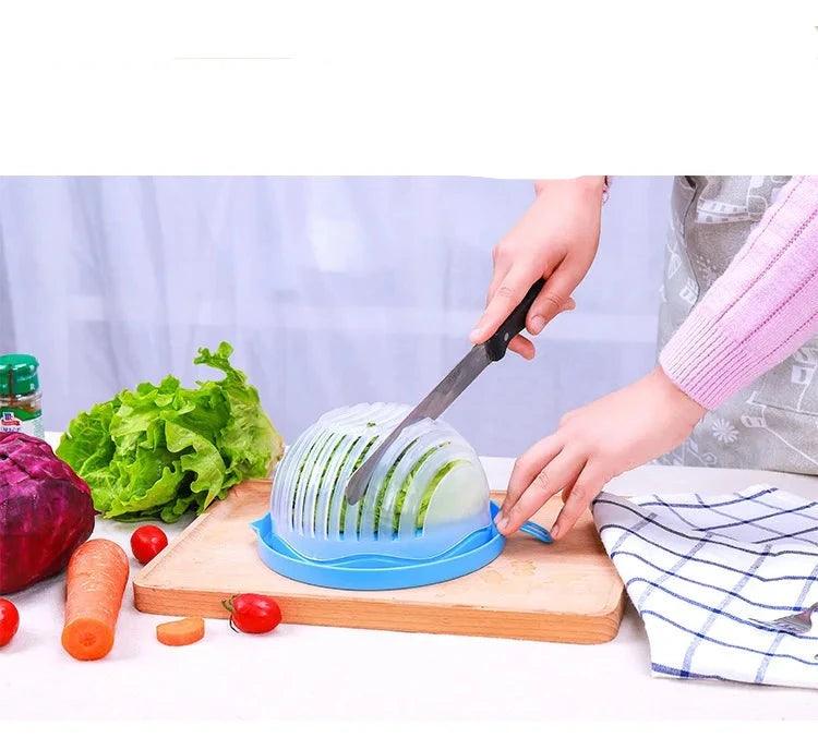 Using the Salad Cutter Bowl, Vegetable Chopping Bowl, a multi-functional kitchen tool, a person efficiently slices vegetables on a wooden cutting board. Surrounding ingredients include lettuce, red cabbage, a carrot, and cherry tomatoes. A striped cloth lies to the side—a perfect setting for meal prep with essential vegetable tools.