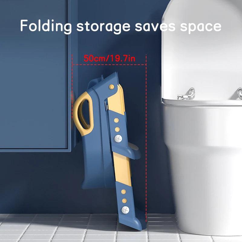 A "Children's toilet stool" in blue and yellow is neatly stored against a bathroom wall next to a toilet. Ideal for baby toilet training, this "Foldable foot stool" conserves space efficiently. The text on it reads, "Folding storage saves space," featuring measurements of 50cm/19.7in.