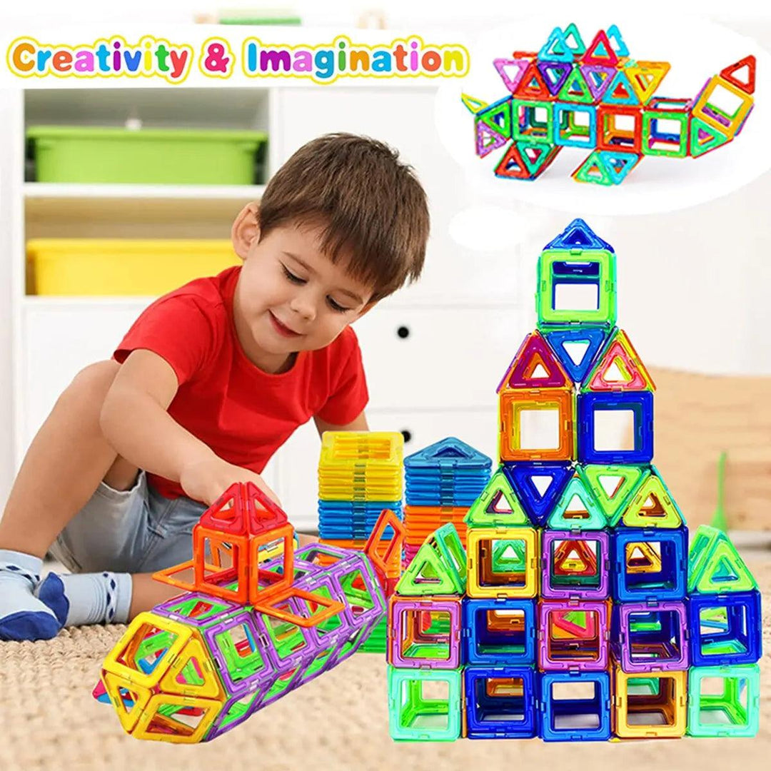 A child in a red shirt sits on the floor, engaging in educational play with the *Magnetic Building Blocks DIY Magnets Toys Kids Designer Construction Set*. The blocks are stacked in various shapes, such as a tall tower and a small figure resembling an animal. Text above reads "Creativity & Imagination.