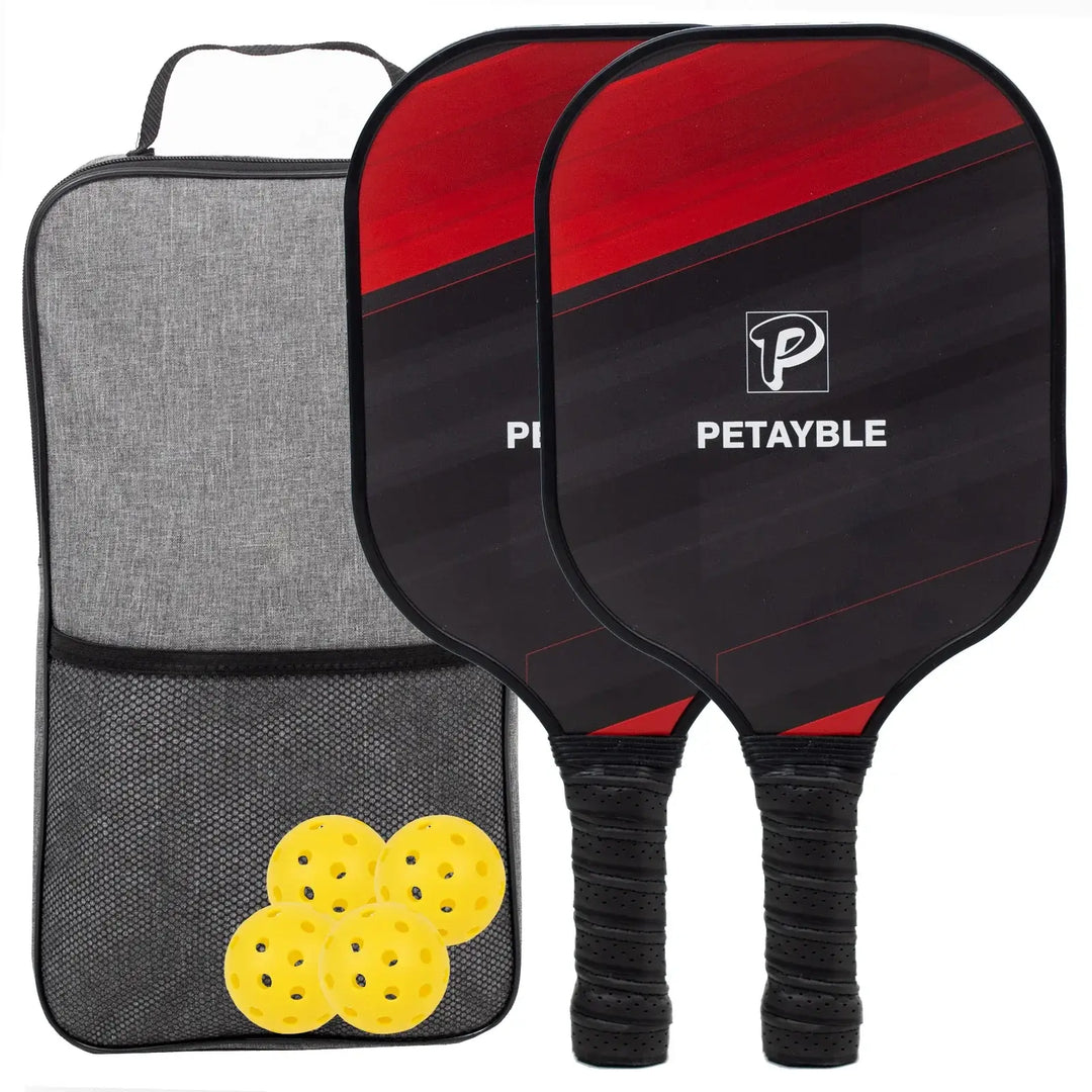 The Fiberglass Surface Pickleball Set offers lightweight and durable paddles with ergonomic cushion grips in a striking red and black design. It includes a gray carrying case with a mesh pocket, along with four yellow perforated balls.