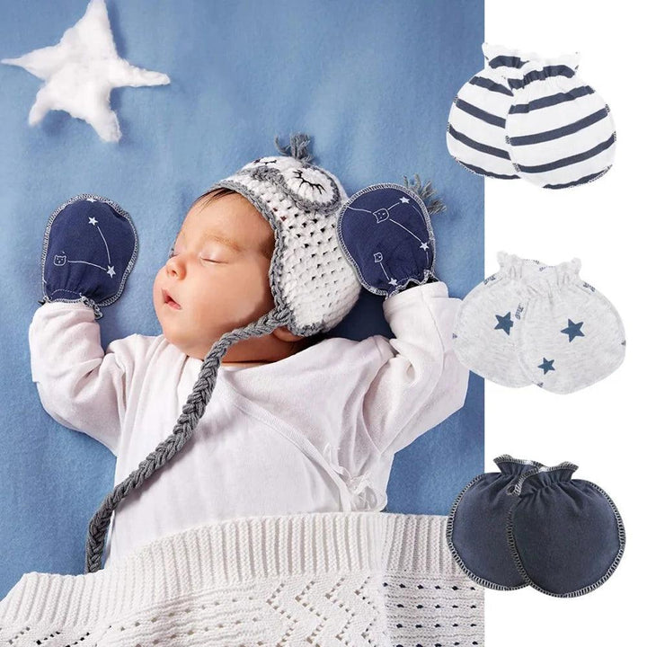 A sleeping baby, wearing a knitted owl hat and cozy mittens from the Newborn Baby Gloves Cotton Infant Mittens Baby Accessories Set, lies on a blue blanket with a crocheted star above. Three pairs of mittens—striped, star-patterned, and solid—are displayed on the right, completing this adorable set of baby accessories.