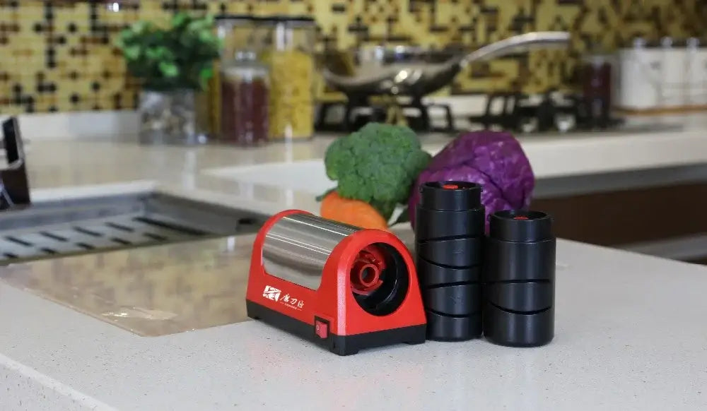 Electric knife sharpener with diamond stones on a kitchen counter beside fresh vegetables.