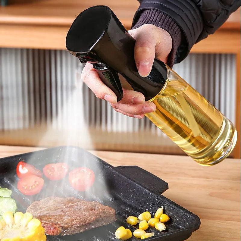 Using an Oil Spray Bottle - Kitchen BBQ Cooking Olive Oil Dispenser - Camping Baking Empty Vinegar Soy Sauce Spray, a person coats a grilling pan filled with vegetables and steak. The eco-friendly bottle, crafted from premium PET, releases a fine mist over the sizzling food as steam rises, with the hand carefully guiding the spray above the pan.