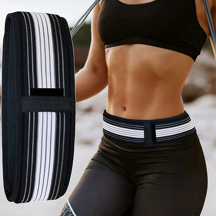 A person wearing a black sports bra and leggings exercises with the SI Joint Support Brace, a hula hoop-like fitness belt engineered for lower spine support. The black brace, accented with white stripes, offers stability, while a close-up on the left showcases its effective design.