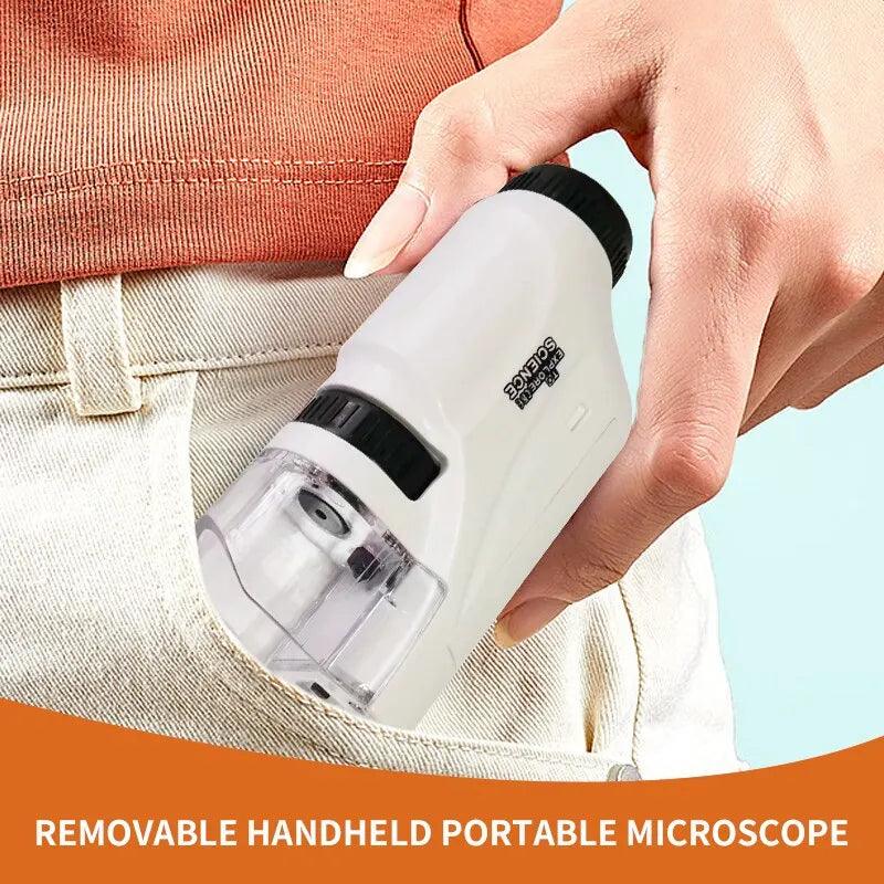 A person slips a Microscope Portable Laboratory, featuring a transparent lens and black focus wheel, into their pocket. An orange banner at the bottom announces, "REMOVABLE HANDHELD PORTABLE MICROSCOPE," highlighting its impressive magnification range.