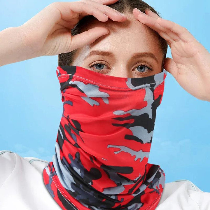 Under a clear blue sky, a blue-eyed individual adjusts their red, black, and gray camo-patterned "Silk sun protection bib." This "Motorcycle neck cover" is ideal for outdoor enthusiasts, seamlessly blending style and functionality for adventurers.