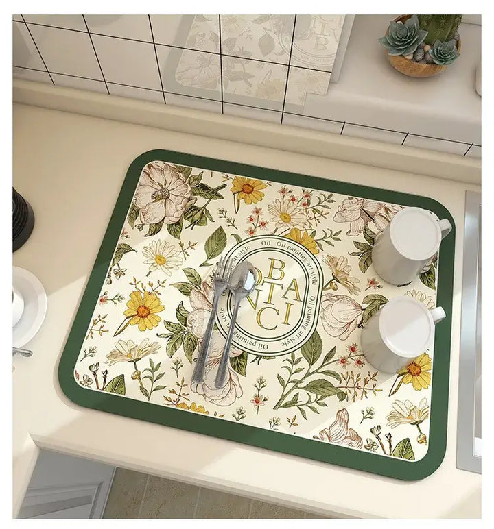 Floral kitchen mat with utensils on a counter, featuring diatom mud material for quick drying and antiskid properties.