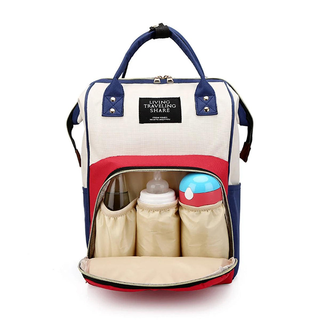 The Portable Multi-Functional Mommy Bag, also known as the Diaper Bag Backpack, is a stylish and practical choice for modern moms. It features blue, red, and beige panels with two handles. The backpack-style design includes a zipper compartment that opens up to reveal convenient storage for baby bottles and containers. A front label reads "Living Traveling Share," making it perfect for the mom on the move.