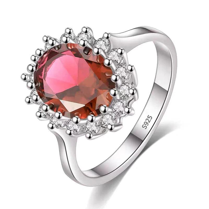 A luxurious and elegant Tibetan Created Ruby/Sapphire Ring, showcasing a large oval Tibetan Created Ruby surrounded by small clear stones in individual prongs. Crafted from sterling silver and engraved with "S925," this exquisite piece of gemstone jewelry stands out for its handcrafted design.