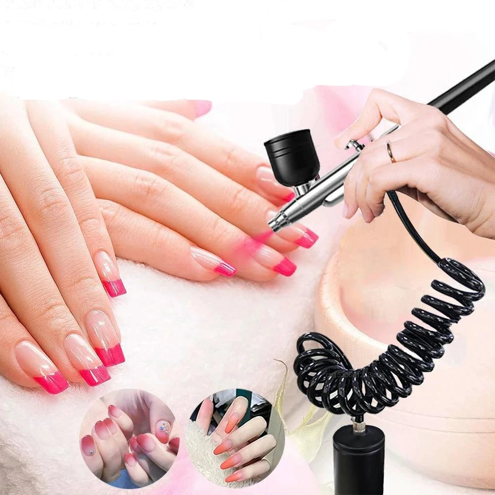 A person is employing the Portable Air Brush Cordless Mini Airbrush Nail Decoration Makeup to create a pink gradient on someone else's nails. The image features close-ups of breathtaking pink ombré designs, with a coiled cable emphasizing the airbrush's compact design.