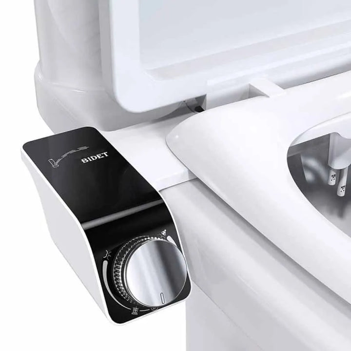 A close-up of a toilet highlights the Bidet Attachment Ultra-Slim Bidet Non-Electric Sprayer. The black control panel, equipped with a shiny silver dial, features easy-to-understand adjustment icons. With the lid open, the double nozzle is visible inside the toilet bowl.