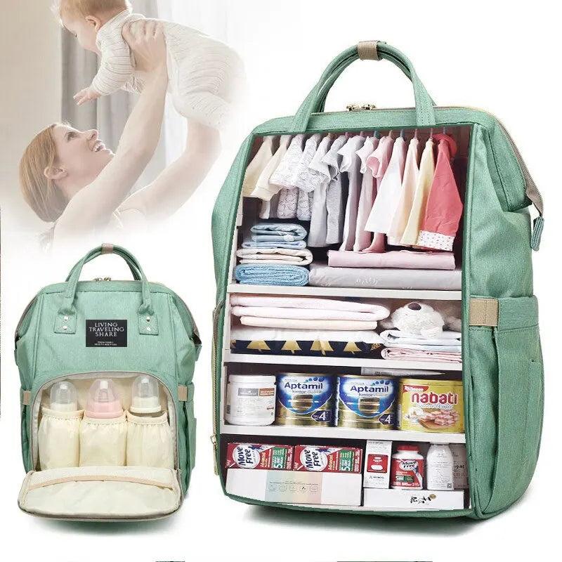 A green Diaper Bag Mummy Backpack with a waterproof exterior and organized compartments is perfect for holding clothes, bottles, milk powder, and baby food. In the background, an image depicts a woman lifting her baby.