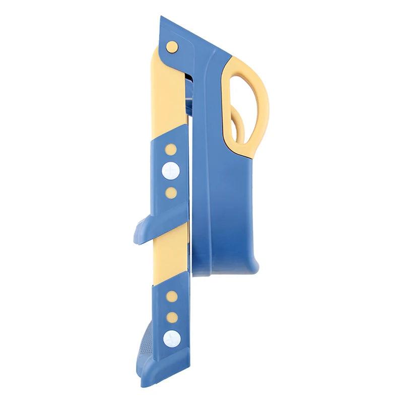 A foldable saw in blue and yellow, with an ergonomic handle designed for easy portability and storage—reminiscent of a children's toilet stool. The saw blade is partially visible, incorporating safety guards and locking mechanisms.