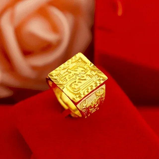 An adjustable men's ring, available for purchase under the name "adjustable mens ring," showcases intricate engravings of an 18K rose gold dragon design, set against a blurred red backdrop with a soft-focused rose.