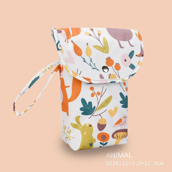 This Baby Diaper Bag Waterproof, Organizer Mummy Storage Bag showcases a whimsical animal and nature pattern with vibrant rabbits, birds, and leaves. Equipped with a button closure and handle, this waterproof pouch makes an ideal mummy storage bag or baby diaper bag. Measuring 11 x 7.5 x 21.5 cm, it is set against a light peach background.