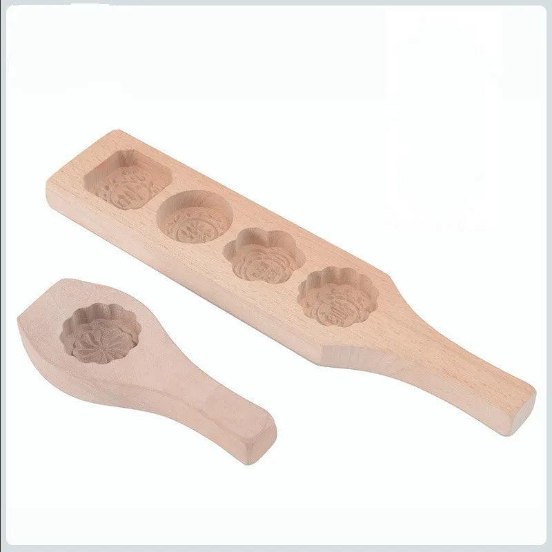 Introducing the Wooden Cookies Mold collection: eco-friendly designs with versatile shapes. One mold features four circular cavities, while the other highlights a single floral cavity. Both molds are equipped with handles for convenient use.