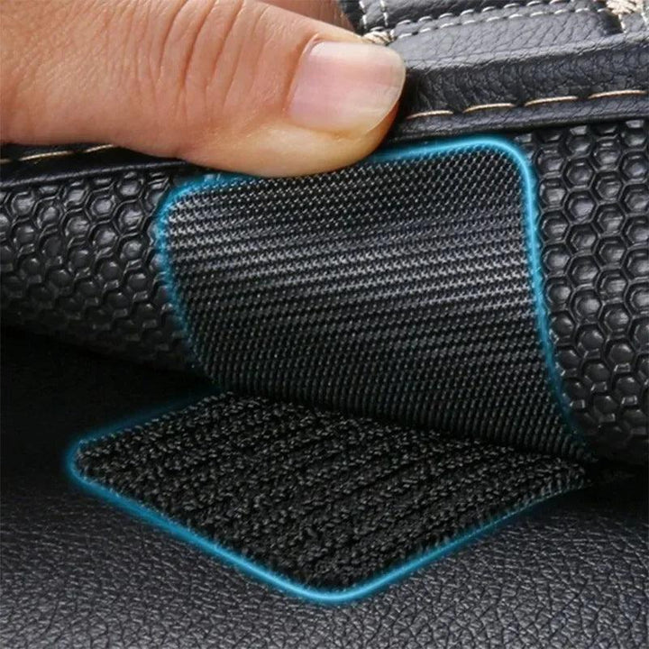 A close-up of a hand lifting a corner of Double-Faced Adhesive Stickers, revealing a patch with heavy-duty grip similar to Velcro underneath. The top layer features a textured, hexagonal pattern reminiscent of car floor mat stickers, while the bottom layer appears smooth and black.