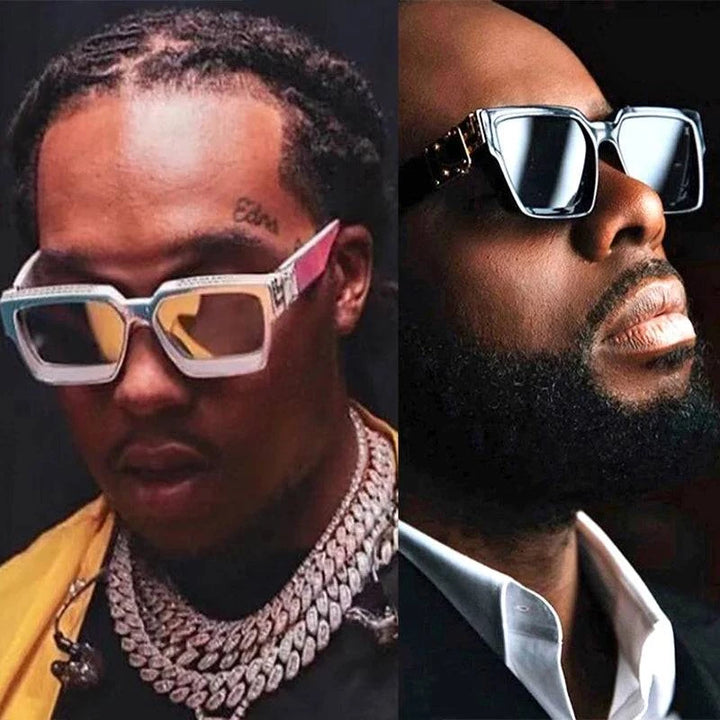 Two fashion-forward individuals donning Luxury Designer Square Glasses with UV400 protection. The left has braided hair and multiple chains, while the right wears a beard and suit. They're against a dark background.