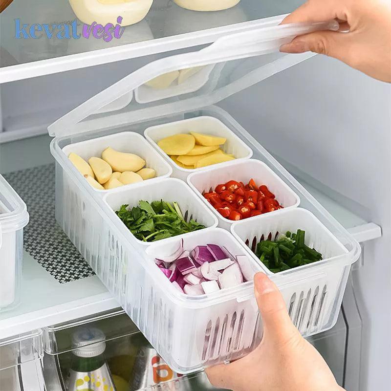 An individual places the Refrigerator Storage Box into the fridge. This clear, compartmentalized organizer holds sliced potatoes, garlic, chopped tomatoes, cilantro, onions, and green peppers—perfectly arranging fresh produce for easy access.