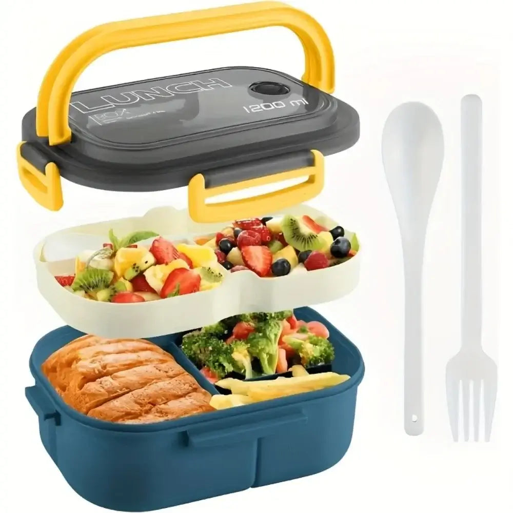 Introducing the Lunch Box Double Layered in a blue and white design with yellow handles. This eco-friendly lunch box features two compartments: one for sliced bread and broccoli, and the other for a colorful fruit salad. Crafted from food-safe materials, it also includes a white spoon and fork placed next to it.