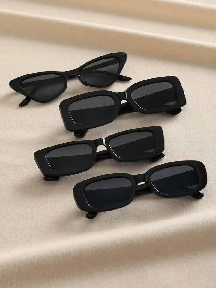 Four pairs of Geometric Plastic Frame Sunglasses with UV400 protection, featuring diverse shapes such as cat-eye, rectangular, and oval, are elegantly displayed on a beige fabric background.