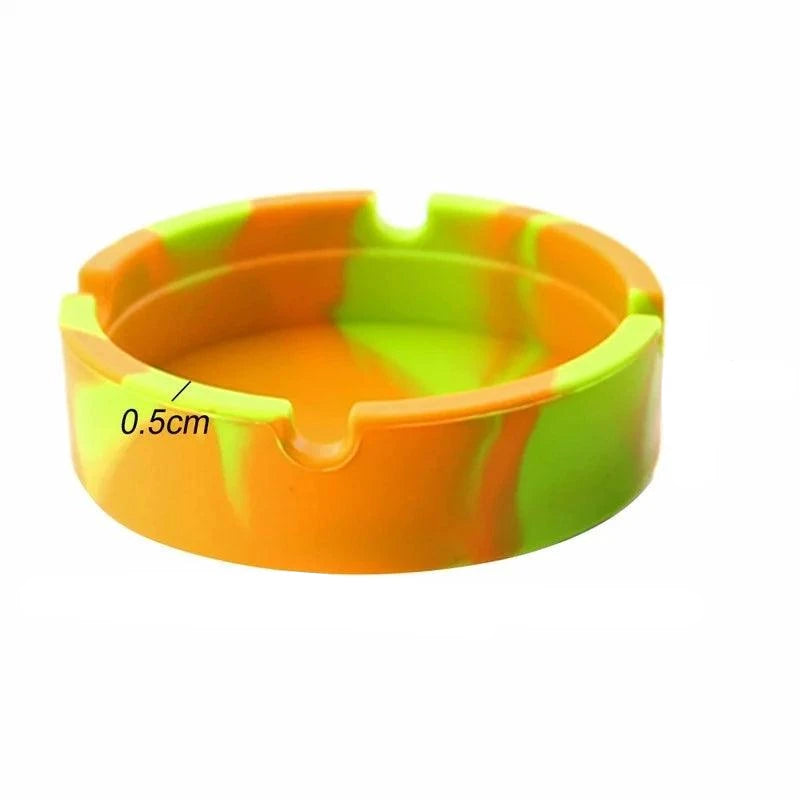 Introducing the Silicone Gel Ashtray, a vibrant circular piece crafted from premium silicone. This fluorescent ashtray showcases a marbled design in orange, green, and yellow hues. It's heat-resistant and thoughtfully designed with a notch for cigarette holding. The inner rim features a measurement label of 0.5 cm for added convenience.