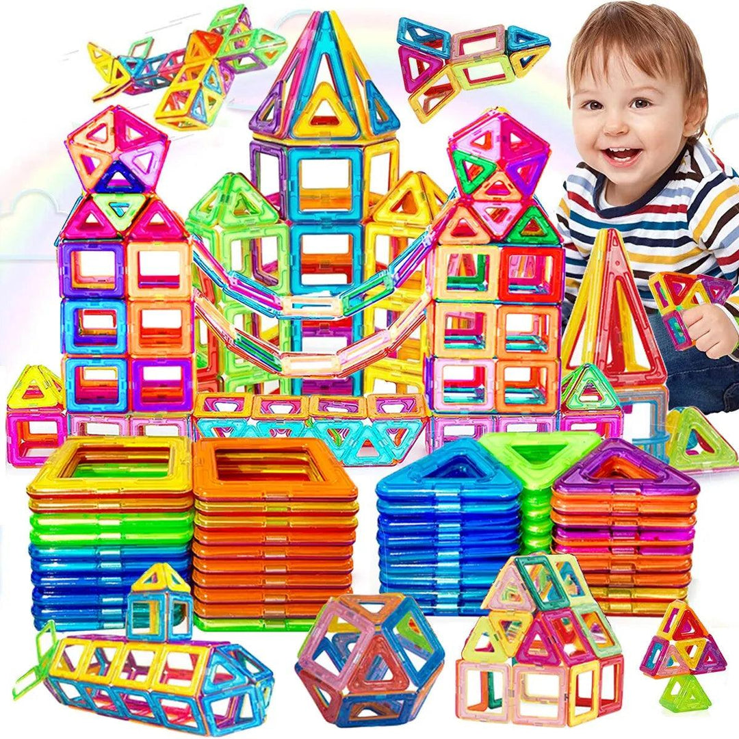 A child beams with joy while engaging in educational play using the Magnetic Building Blocks DIY Magnets Toys Kids Designer Construction Set. Constructing various geometric shapes such as towers and houses, the vibrant pieces—which include squares, triangles, and hexagons in a rainbow of colors—make learning an enjoyable experience.