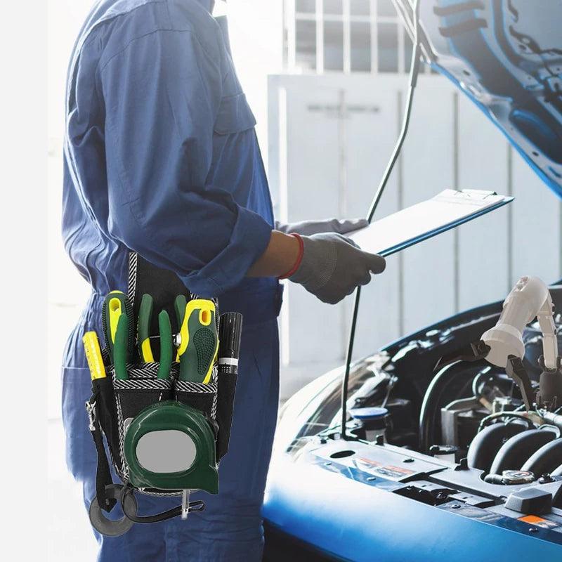 A mechanic in blue coveralls stands beside an open car hood, holding a clipboard, while their Multifunctional Tool Bag Electrician Waist Pocket Portable Tool Pouch displays organized storage. The durable nylon fabric gleams in the sunlight streaming through a window, reflecting the precision and reliability essential for every task.