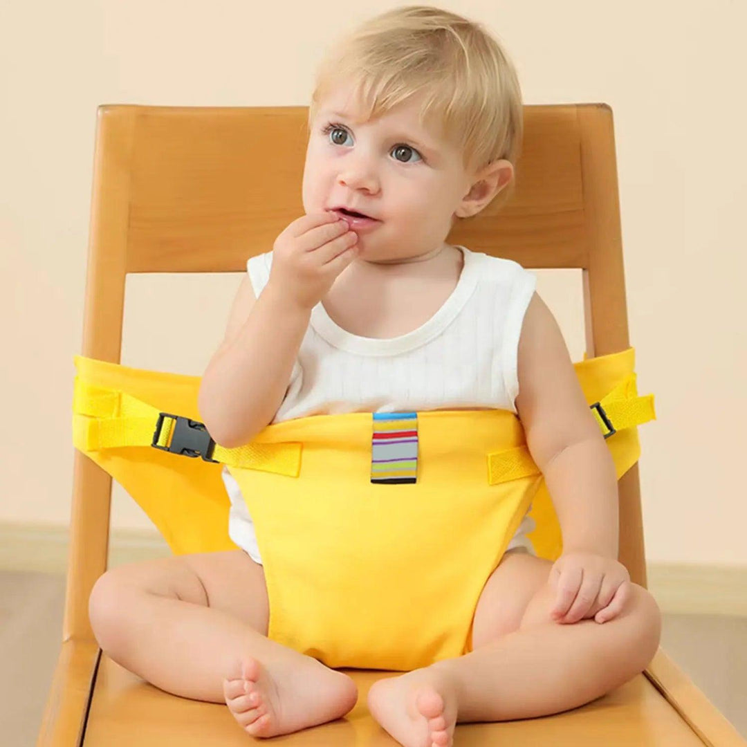 A blonde-haired toddler sits on a wooden chair, safely secured by the Children's Safety Harness Portable Child Harness Alternative to Child Seats in a vibrant yellow. The durable polyester fiber of the harness provides extra security as the child, dressed in a white sleeveless shirt, thoughtfully places one hand near their mouth against the soft beige background.