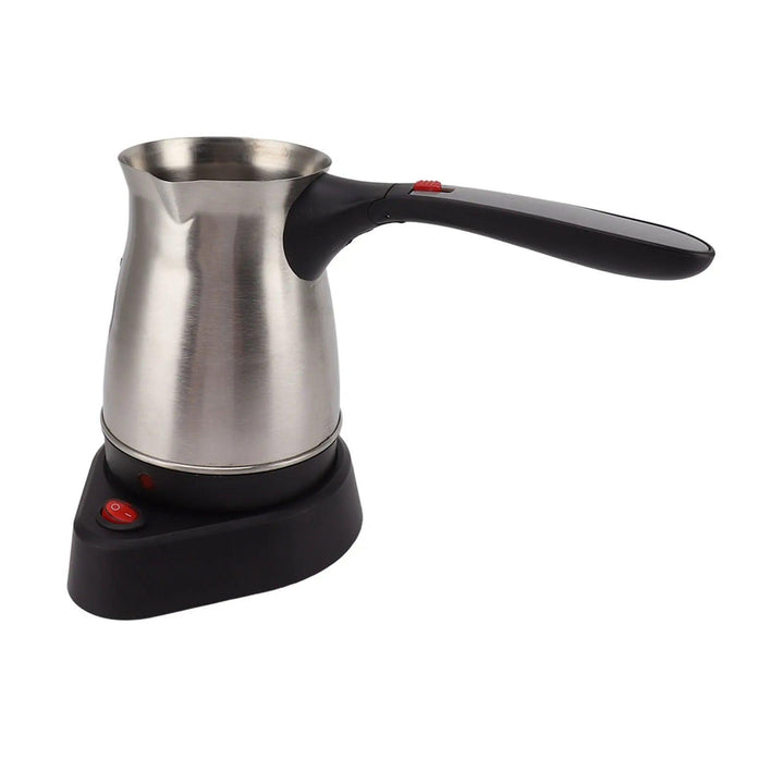 The Turkish coffee maker machine features a sleek stainless steel design with a black foldable handle. Resting on a black base, it includes a red on/off switch button that combines modern aesthetics with efficient brewing. Additionally, the unit is equipped with a dual protection system for safe operation.