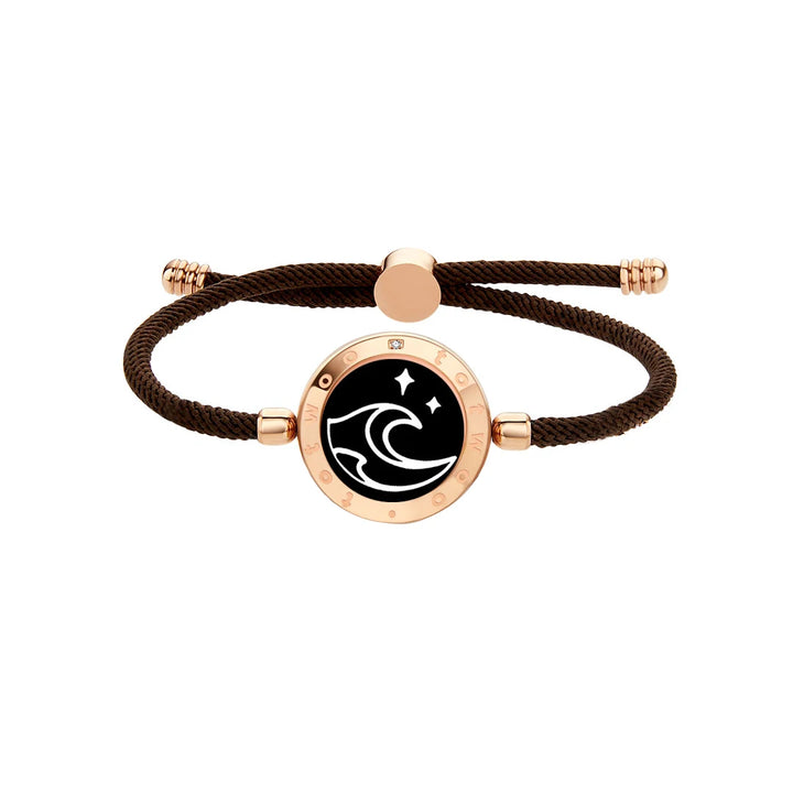 This trendy rope bracelet, known as the Long Distance Bracelet Couple's Jewelry Interactive Love Gift, showcases a gold circular charm with a black center. It is elegantly decorated with a white wave design and stars. Designed as a symbol of connection, it features gold end caps and an adjustable sliding clasp, making it the perfect gift for celebrating relationships.