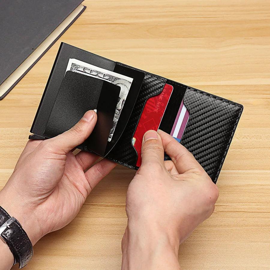 A person holding the stylish Carbon Fiber Aluminum Wallet, an RFID Slim Card Case that effortlessly combines style and security by featuring money and credit cards with its automatic pop-up card holder.