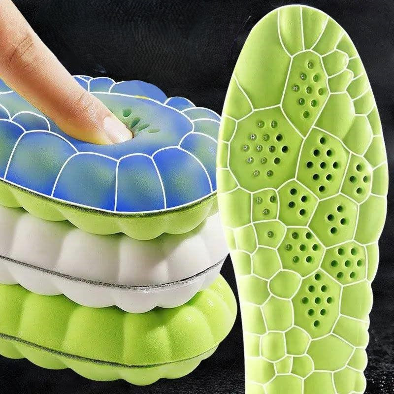 A close-up of the 4D Massage Insoles Arch Support Orthopedic Inserts Unisex Comfort Insoles reveals a vibrant hexagon pattern. A finger presses on a blue insole, highlighting its softness and shock-absorbing qualities. The stack also features green and white insoles, with the green one demonstrating detailed arch support.